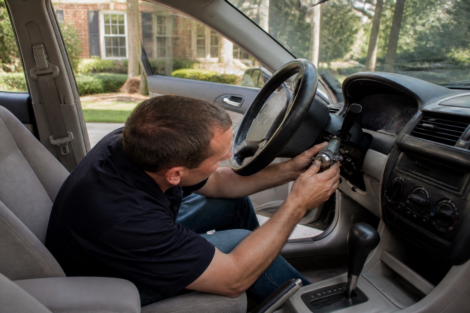 Technician replacing an ignition cylinder in a driveway in Orlando, Florida.