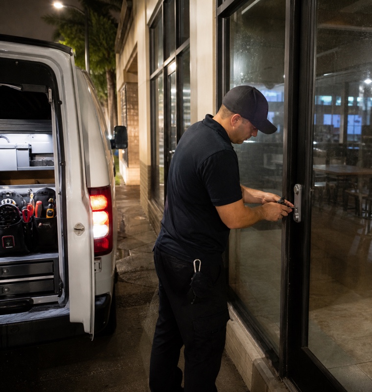Technician and service van outside a storefront at night in Orlando, Florida.