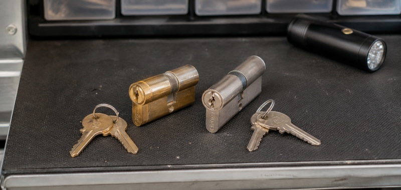 Assembled residential lock cylinders and their newly matched keys on a locksmith workbench in Orlando, Florida.